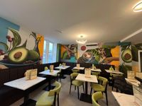 Avo Coffee indoors view - green chairs and avocado themed walls!